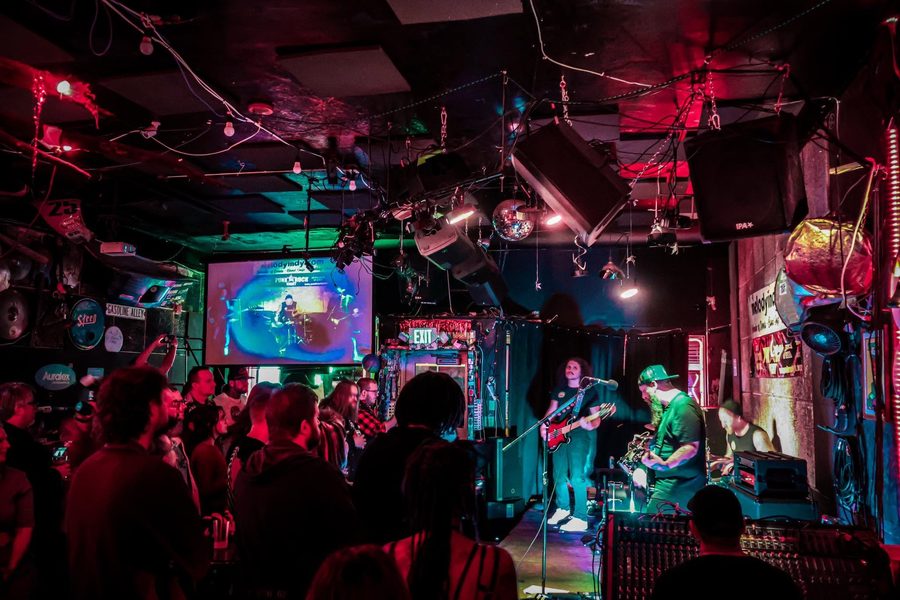 Pretty With The Lights Out playing to a packed room under red and green lights
